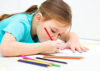 Image showing Little girl is drawing using pencils