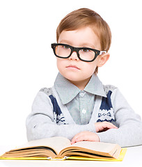 Image showing Little child play with book