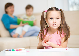 Image showing Little girl is playing with plasticine