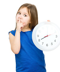 Image showing Little girl is holding big clock