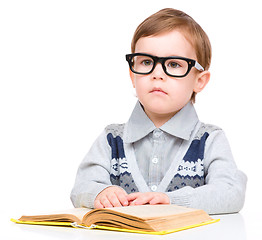 Image showing Little child play with book