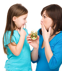 Image showing Little girl and her mother are anxious about time