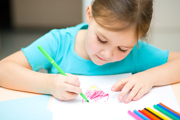 Image showing Cute cheerful child drawing using felt-tip pen