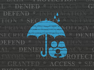 Image showing Protection concept: Family And Umbrella on wall background