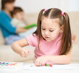 Image showing Little girl is playing with plasticine