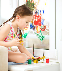 Image showing Portrait of a cute girl playing with paints