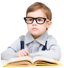 Image showing Little child play with book