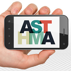 Image showing Health concept: Hand Holding Smartphone with Asthma on  display