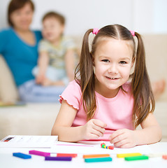 Image showing Little girl is playing with plasticine