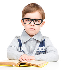 Image showing Little child play with book