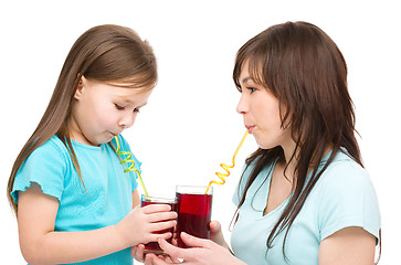 Image showing Mother and her daughter are drinking juice