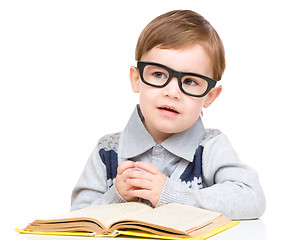 Image showing Little child play with book