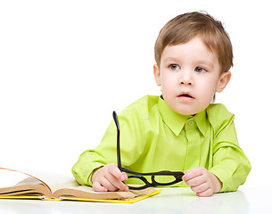 Image showing Little child play with book