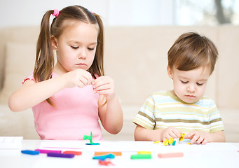 Image showing Sister and brother are playing with plasticine