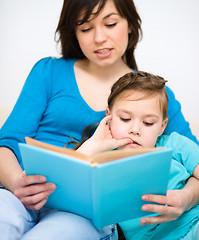 Image showing Mother is reading book with her daughter