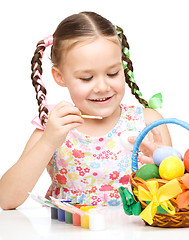 Image showing Little girl preparing eggs for Easter