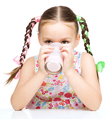 Image showing Cute little girl with a glass of milk