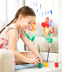 Image showing Portrait of a cute girl playing with paints