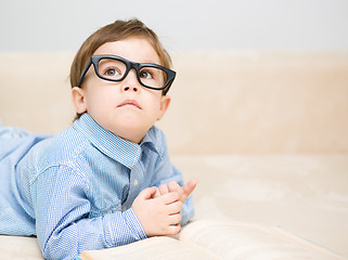 Image showing Little boy is reading book