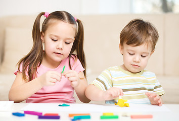 Image showing Sister and brother are playing with plasticine