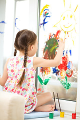 Image showing Portrait of a cute girl playing with paints