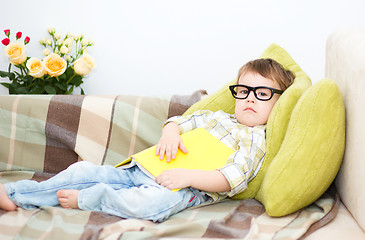 Image showing Little boy is reading book