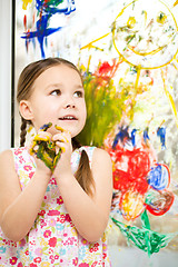 Image showing Portrait of a cute girl playing with paints