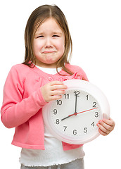 Image showing Little girl is holding big clock