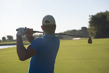 Image showing golf player hitting shot