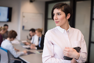 Image showing hispanic businesswoman with tablet at meeting room