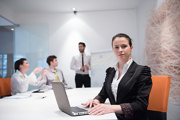 Image showing young business woman on meeting  using laptop computer