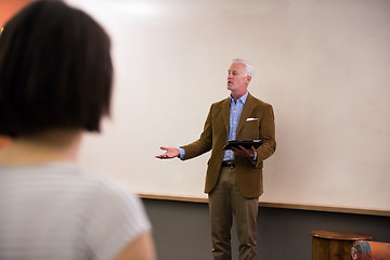 Image showing teacher with a group of students in classroom