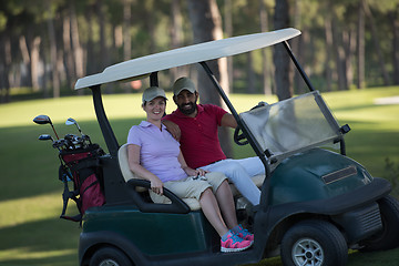 Image showing couple in buggy on golf course