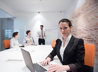 Image showing young business woman on meeting  using laptop computer