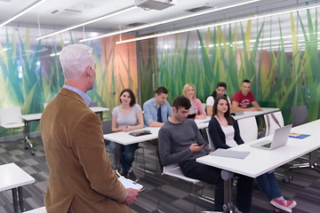 Image showing teacher with a group of students in classroom