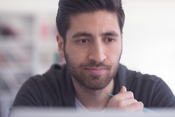 Image showing student in school library using laptop for research