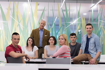 Image showing portrait of  teacher with students group in background