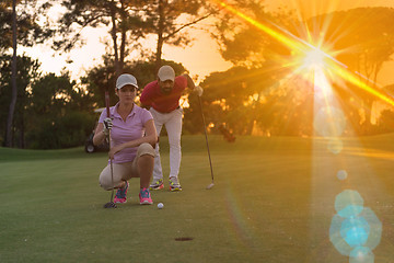 Image showing couple on golf course at sunset