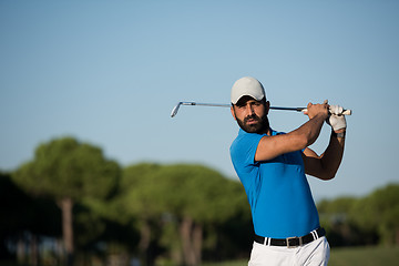 Image showing pro golfer hitting a sand bunker shot