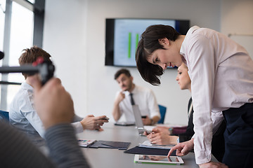 Image showing young  woman using  tablet on business meeting