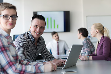 Image showing young business couple working on laptop, businesspeople group on