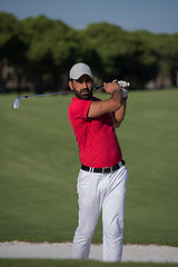 Image showing golfer hitting a sand bunker shot