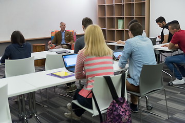 Image showing teacher with a group of students in classroom