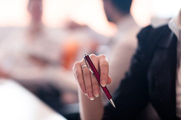 Image showing woman hands holding pen on business meeting