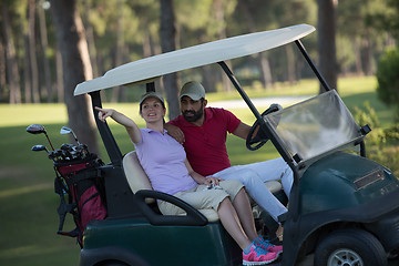 Image showing couple in buggy on golf course