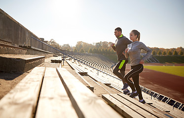 Image showing happy couple running upstairs on stadium