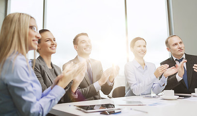 Image showing business team with laptop clapping hands