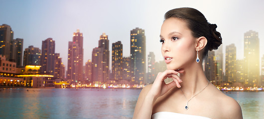 Image showing beautiful asian woman with earring and pendant