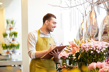 Image showing florist man with clipboard at flower shop