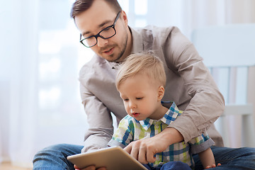 Image showing father and son with tablet pc playing at home